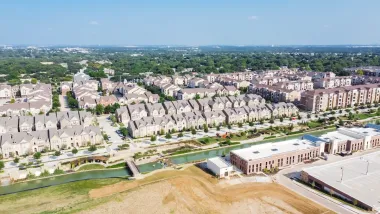Top view new development riverside residential and commercial neighborhood with vacant land in Texas, USA.